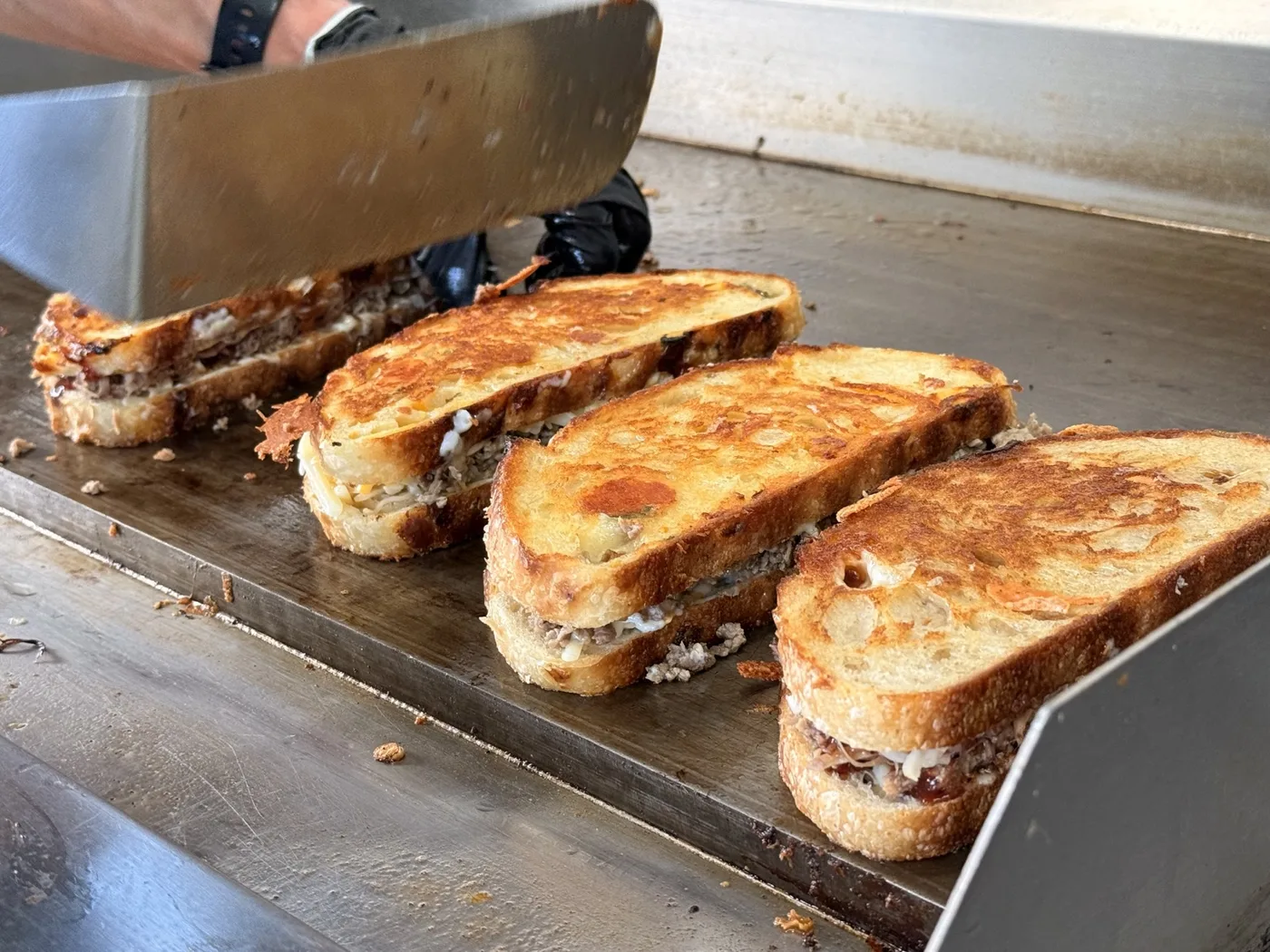 Sandwiches grilling on the flat top